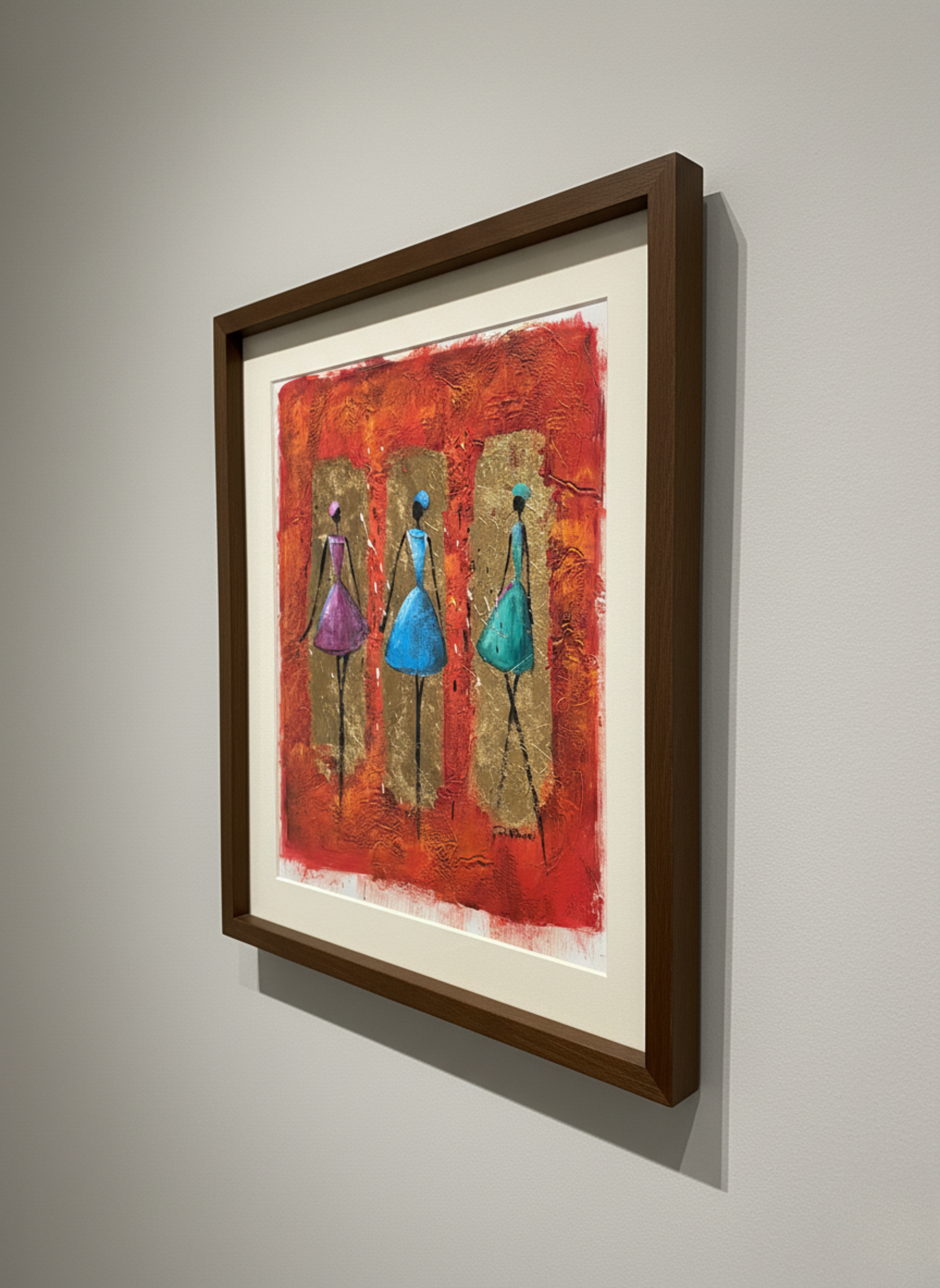 Framed abstract artwork with three figures on a red background, mounted on a wall.