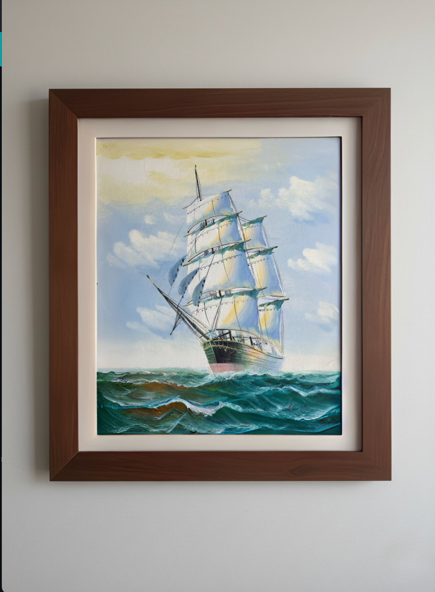 Framed painting of a sailboat on a blue sky and ocean background