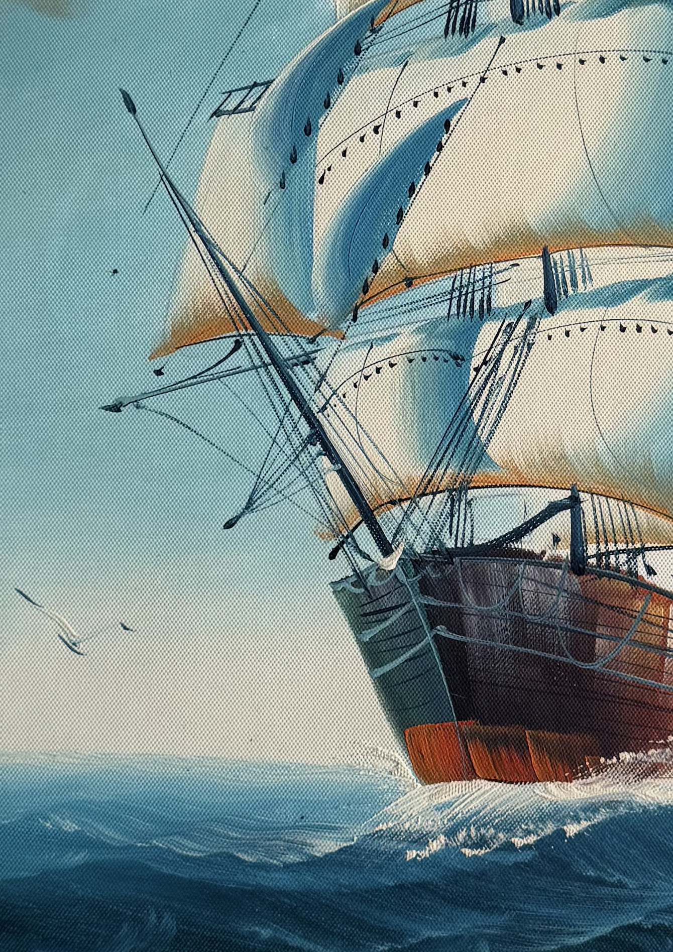 Sailing ship with large sails on a textured blue background