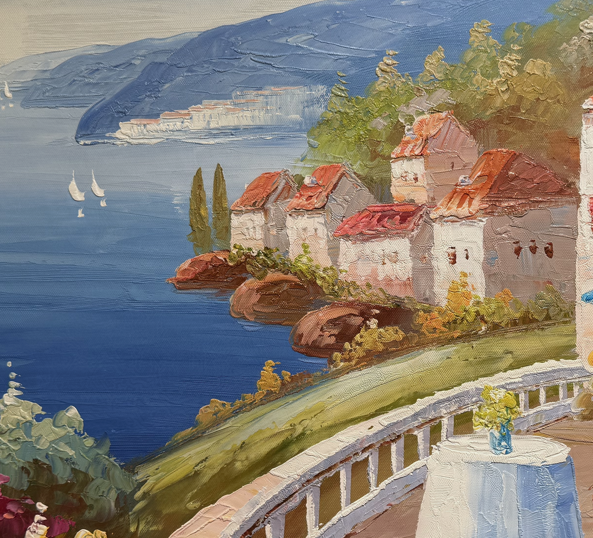 Painting of a lakeside village with red-roofed houses and sailboats.