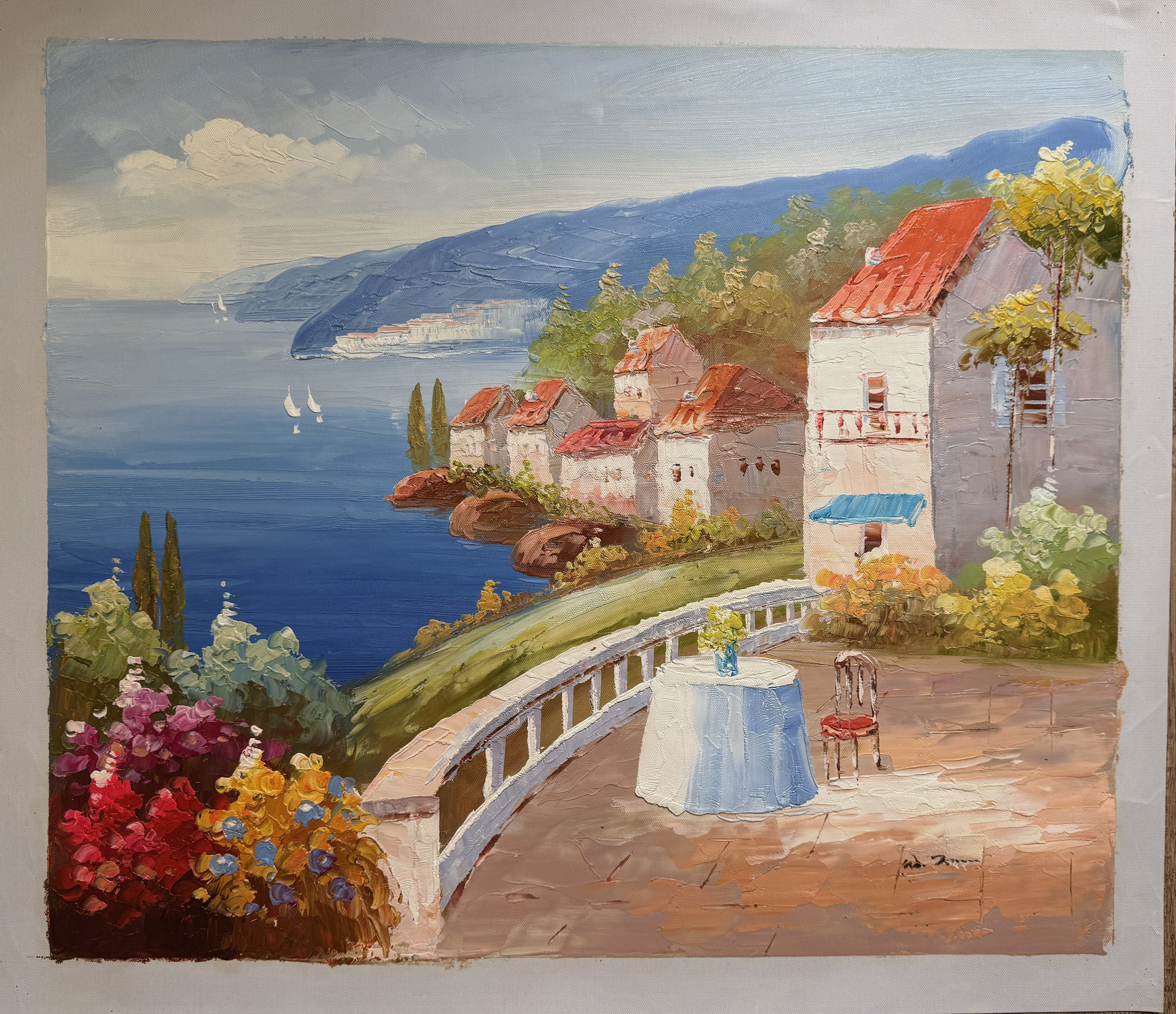 Painting of a coastal scene with houses, a table, and flowers.