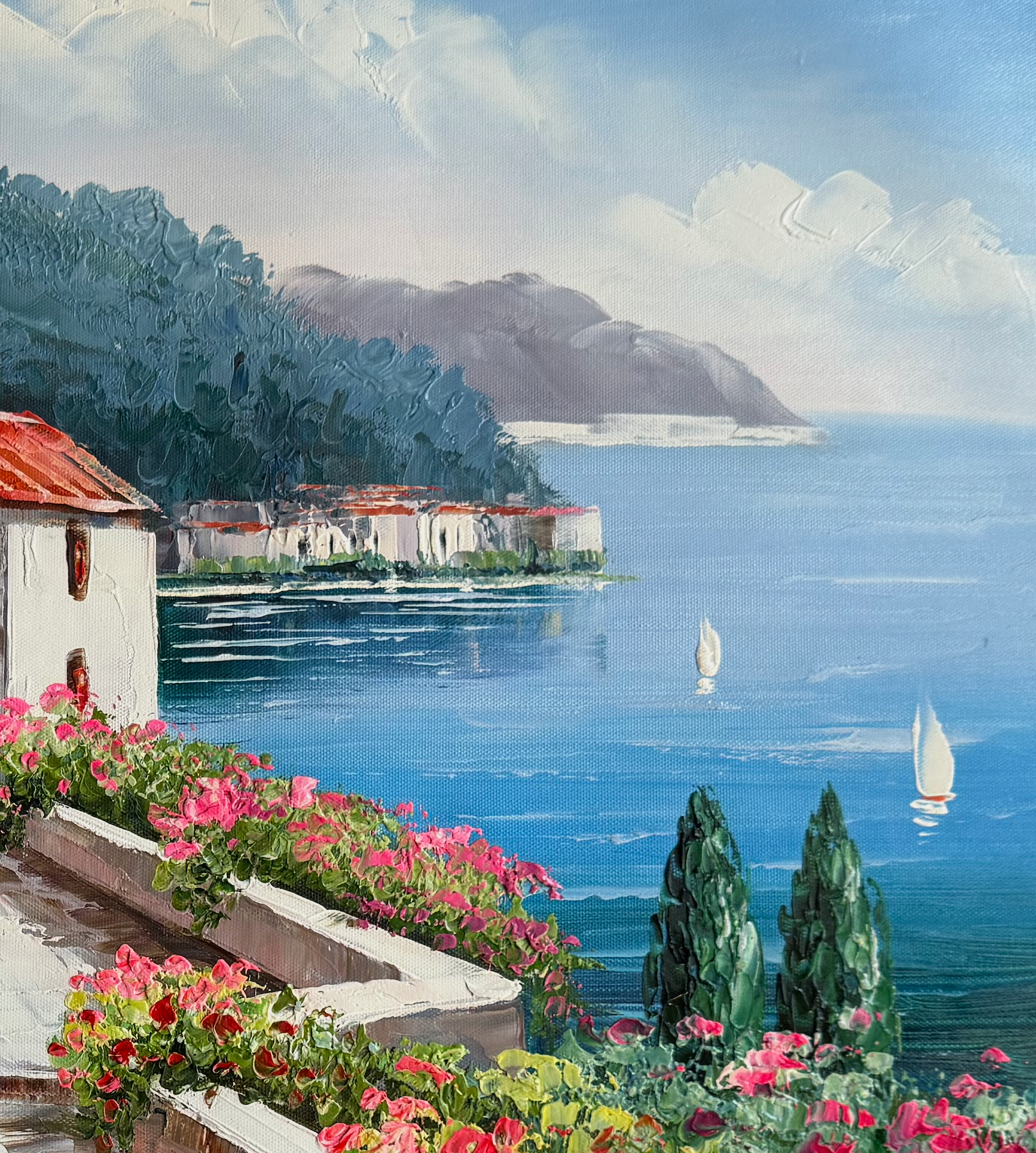 Village by the sea with sailboats and flowers in the foreground