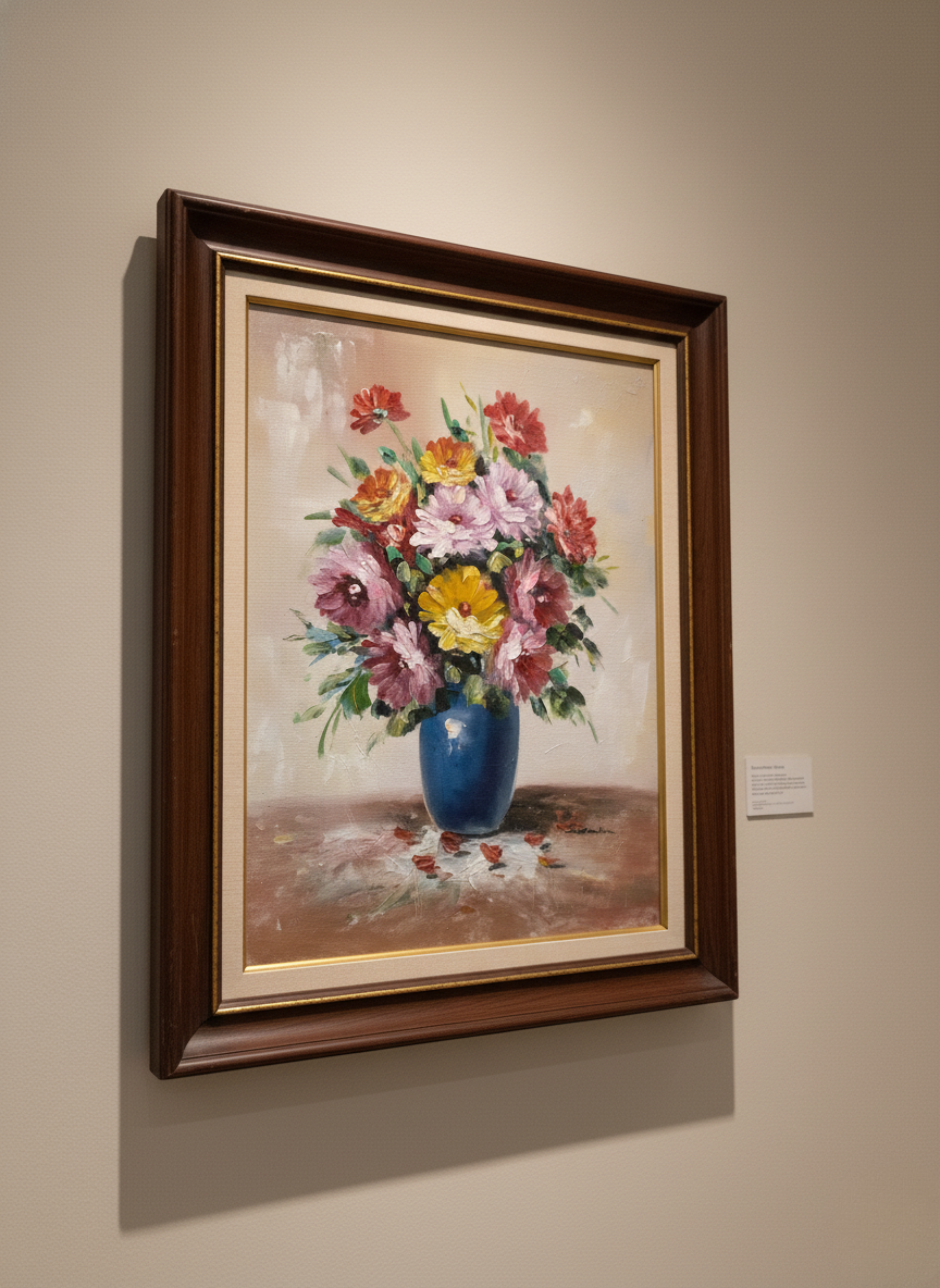 Framed painting of a bouquet of flowers on a beige wall