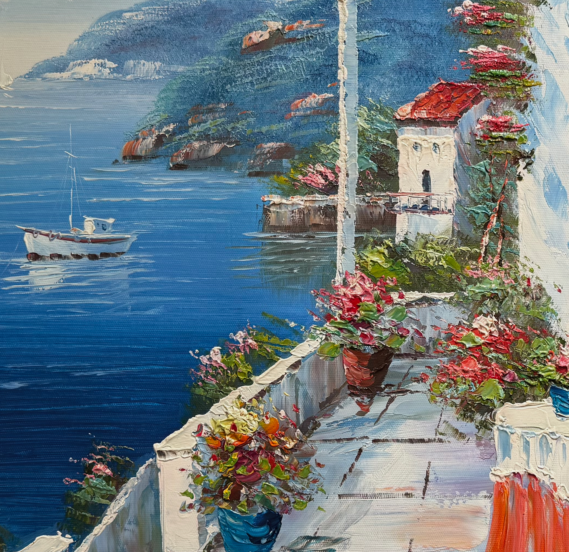 Coastal scene with flowers on a balcony overlooking the sea and boats.
