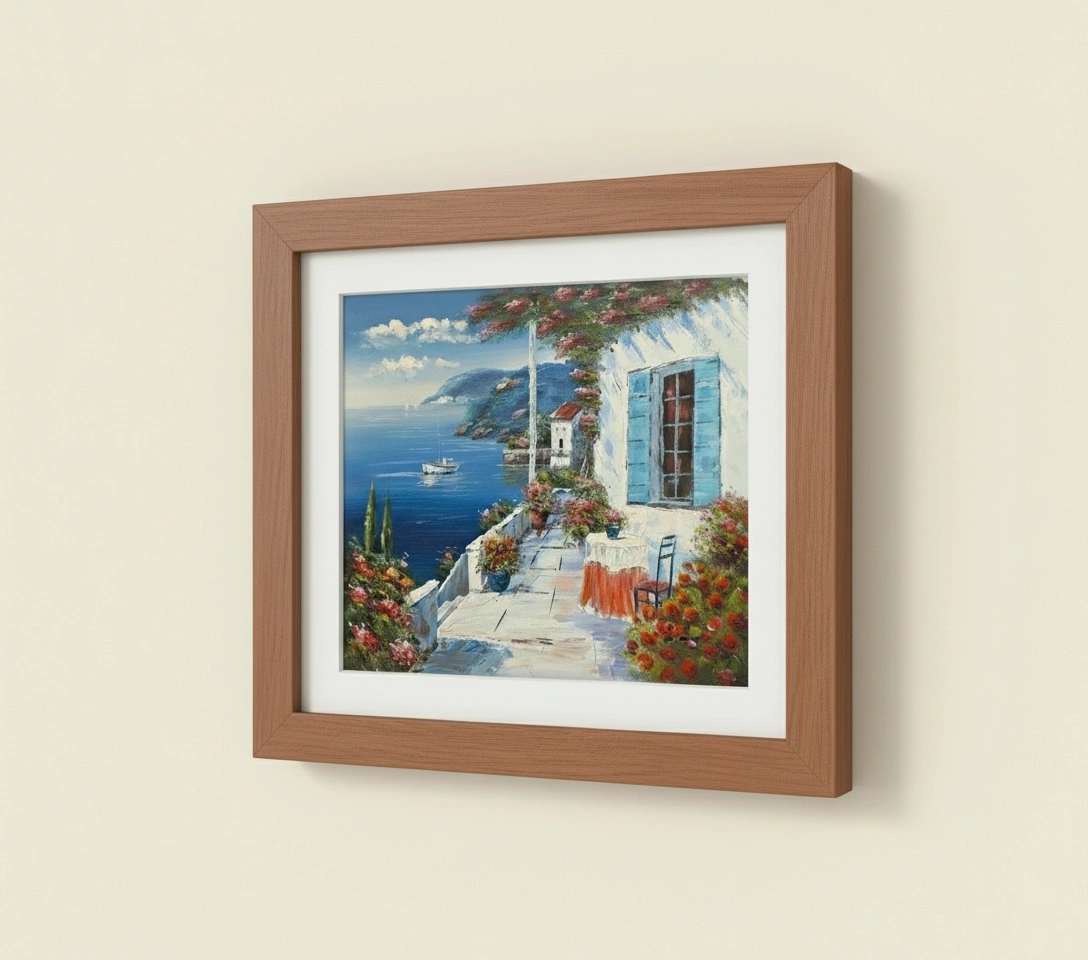 Framed painting of a coastal scene with a house and boat on a beige wall.