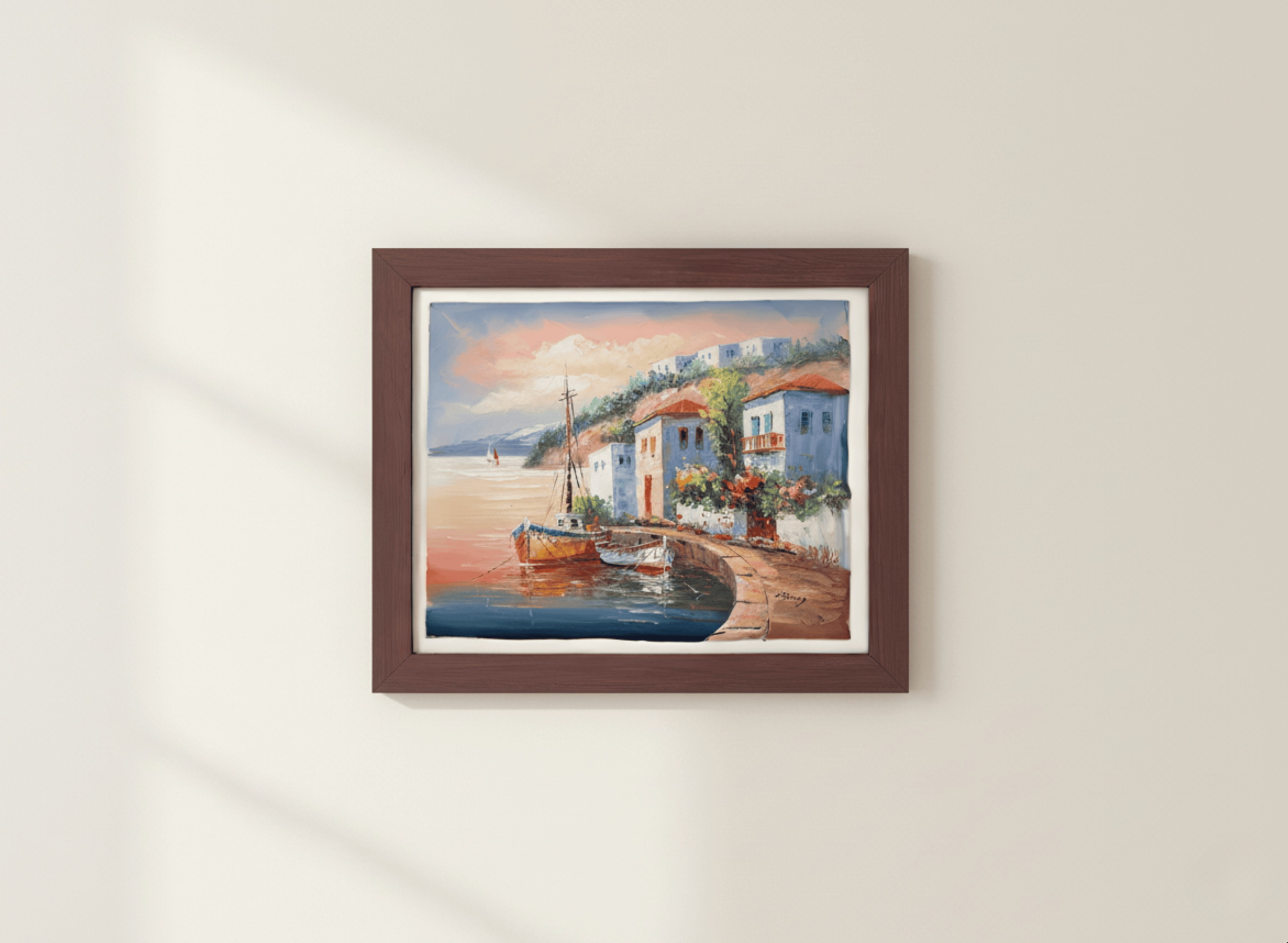 Framed painting of a coastal scene with houses and a boat on a white wall.