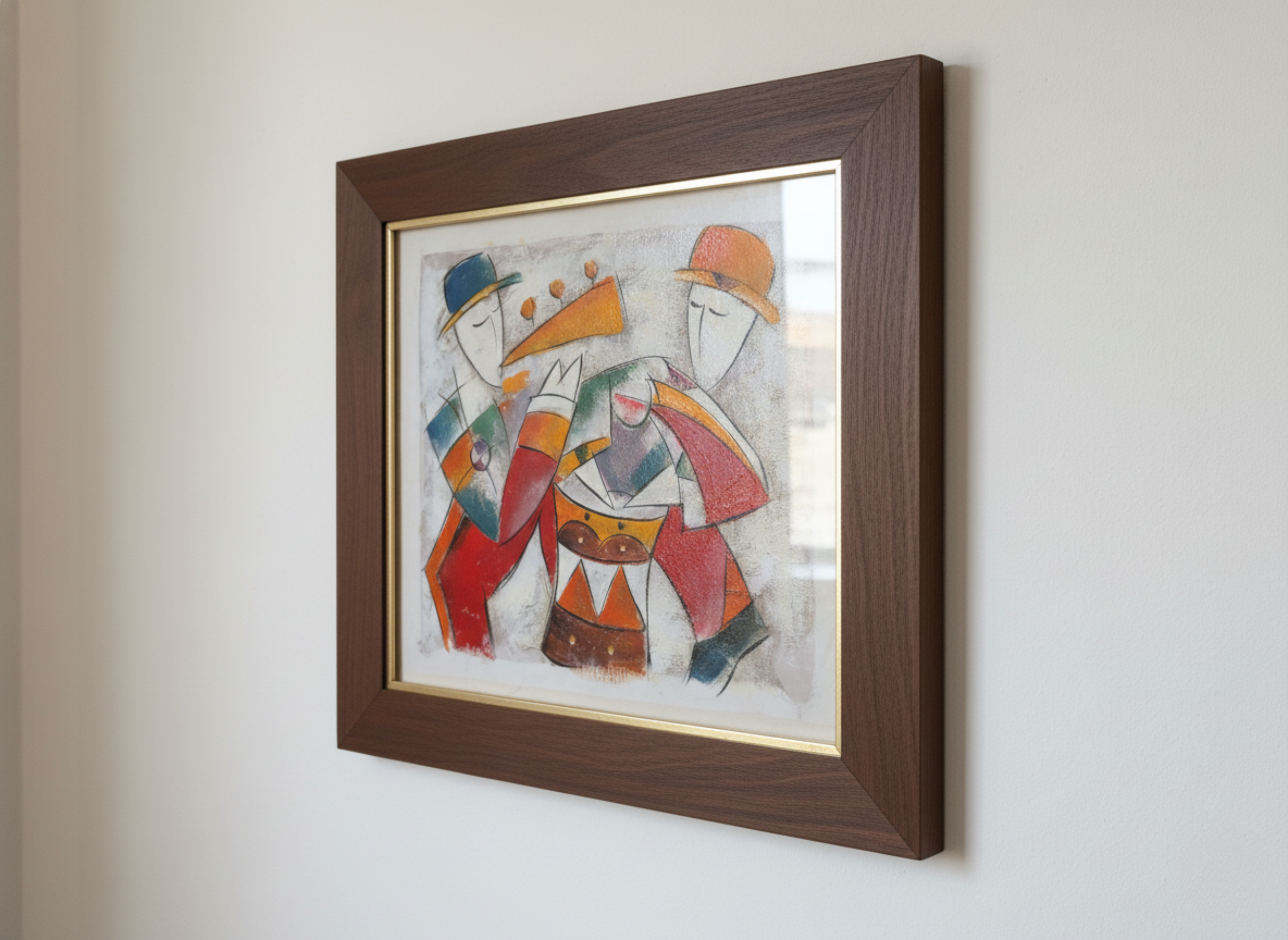 Framed artwork of abstract figures on a white wall