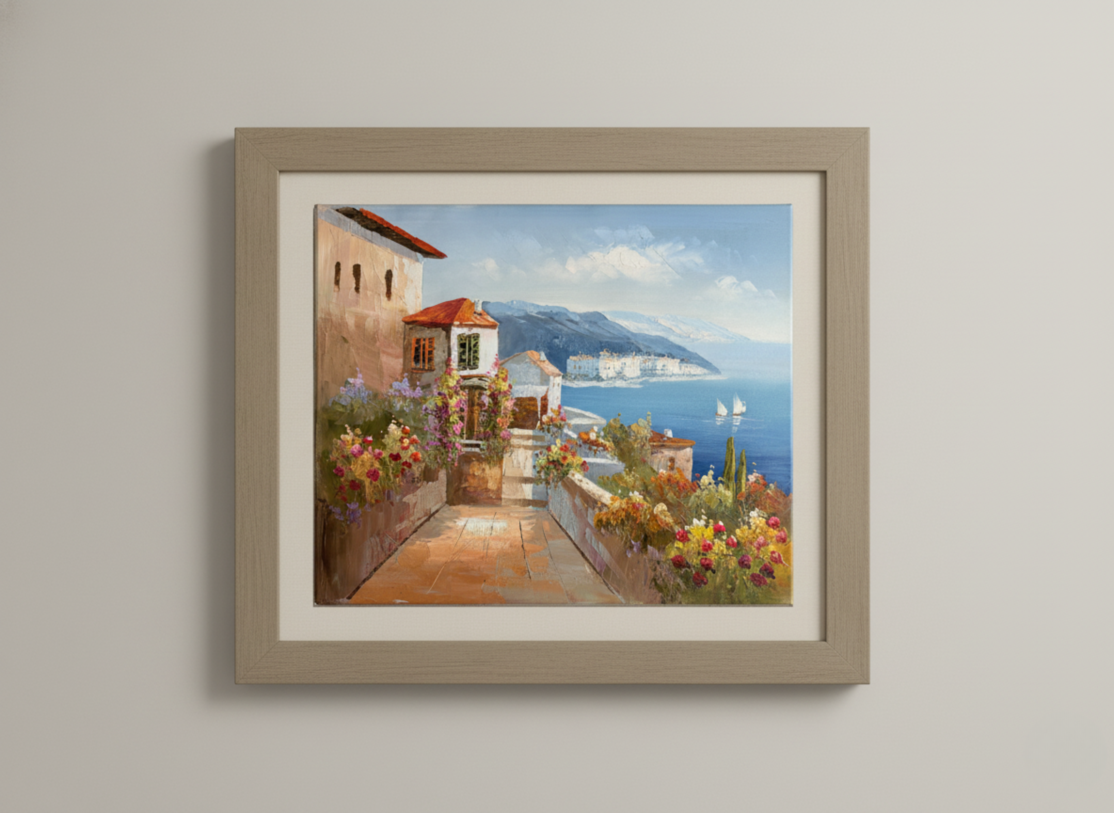 Framed painting of a coastal scene with buildings and flowers on a wall.