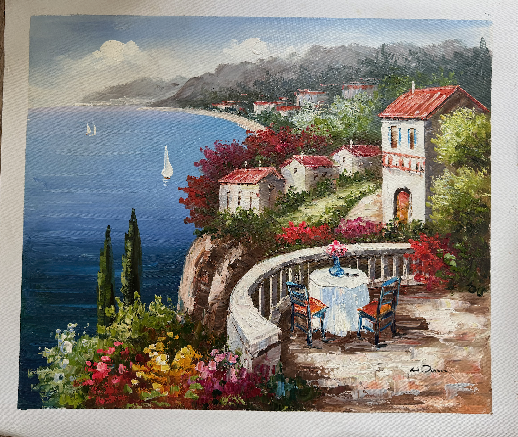 Painting of a scenic coastal landscape with a table and chairs by the sea.